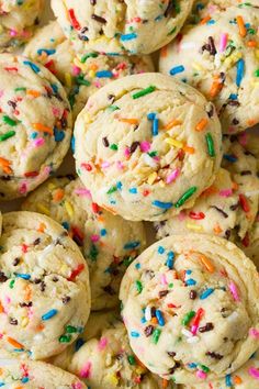 sprinkles and chocolate chip cookies are piled on top of each other