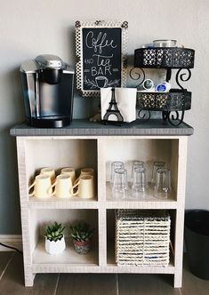 a coffee bar with cups, mugs and other items on the shelf next to it