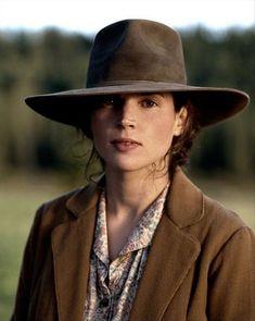 a woman wearing a brown hat and jacket