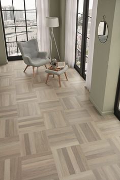 a living room with wood flooring and large glass doors leading to a balcony overlooking the city