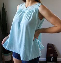 "The sweetest vintage babydoll tank top from the 1960s-70s. Light powder blue color with lace detail. Made by Formfit Rogers. Labeled size Small, 10-12. Fits oversize. Please see measurements for accurate fit! Measurements: Length: 24\" Shoulders: 13\" Chest: 42\" Thank you for visiting Bug B. v i n t a g e t o p s https://www.etsy.com/shop/BugBVintage?§ion_id=26883449 v i s i t t h e s h o p www.BugBVintage.etsy.com i n s t a g r a m @BugBVintage" Blue Sleeveless Sleepwear, Vintage Sleeveless Tops For Loungewear, Vintage Sleeveless Cotton Camisole, Light Blue Sleeveless Tank Top For Loungewear, Sleeveless Tops With Lace Trim For Daywear, Blue Sleeveless Sleepwear With Lace Trim, Retro Blue Sleeveless Top, Blue Lace Trim Sleeveless Sleepwear, Vintage Sleeveless Tops For Daywear