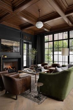 a living room filled with furniture and a fire place in front of a large window