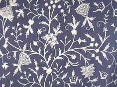 a blue and white wallpaper with flowers on it