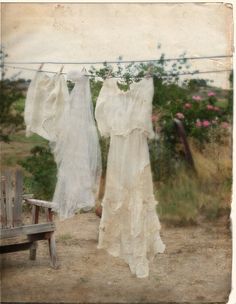 two white dresses hanging on a clothesline with the words,'the feminine home '