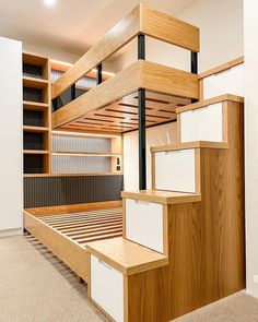 an empty room with wooden stairs and shelves