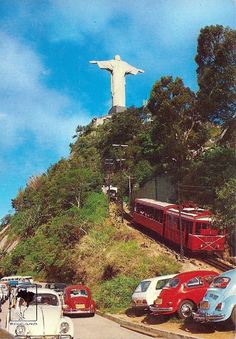 cars are parked in front of the christ statue