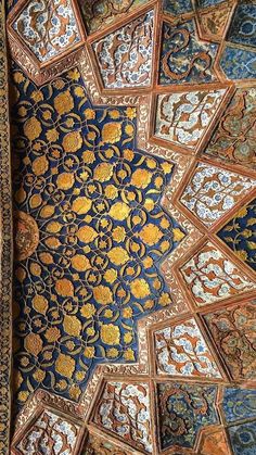 an intricately decorated ceiling in the middle of a room with blue and gold colors