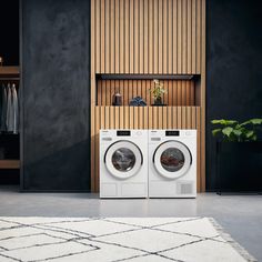 two washers sitting in front of a wooden shelf