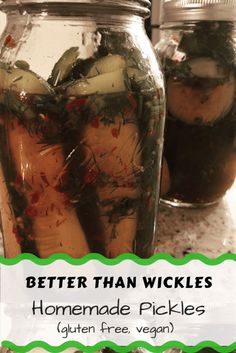 two jars filled with pickles sitting on top of a counter