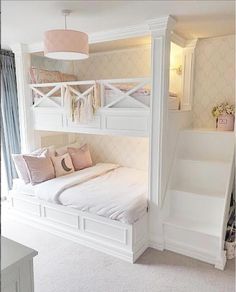 a white bunk bed sitting in a bedroom next to a window with curtains on it