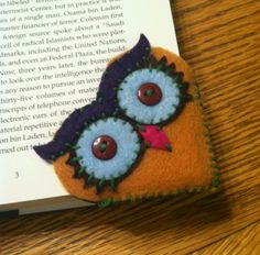 an owl brooch sitting on top of a book