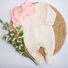 This oatmeal sleeper is personalized with a beautiful cursive stitch, and made just for your little one! It is made of a super soft cotton poly blend and has fold over mittens & footies. This would make the perfect coming home outfit or baby shower gift.  You can order the sleeper by itself or with a matching headband or hat. Options are shown in listing photos.  For sizing reference: Newborn size fits approximately 6-9lbs 0-3 size fits approximately 9-13lbs Please leave the name to be embroidered in the notes to seller box at checkout. I can do first or first and middle name (as shown in photos). Please message me with any questions prior to ordering! Im always happy to help! Current turnaround time is approximately 1-2 weeks from order date. This is subject to change. If needed by a cert Commercial Embroidery Machine, Girl Coming Home Outfit, Pink Stitch, Girls Coming Home Outfit, Personalized Baby Girl, Coming Home Outfit, Matching Headband, Gender Neutral Baby Clothes, Diy Book