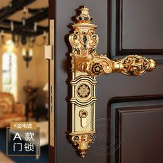 the door handle is gold and has ornate designs on it's front doors,