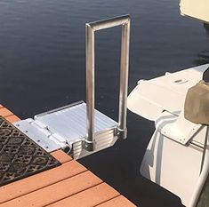 the boat is docked at the dock by the water's edge with its ramp