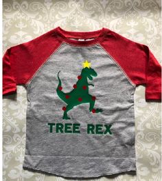 a t - shirt that says tree rex on the front, and a green dinosaur with red