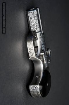 a metal door handle on a black surface with an intricate design and silver hardwares