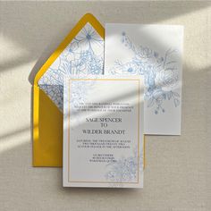 an image of wedding stationery with flowers on the front and yellow envelope liners