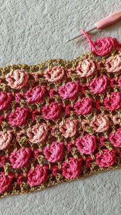 a crocheted pink and brown piece of cloth