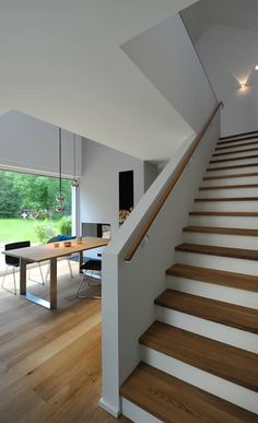 a staircase leading up to a dining room table