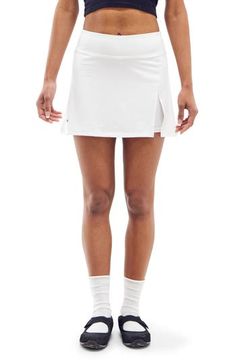 Work out or chill out in this stretchy skort designed with an airy side vent. 13 1/2" length; 4" inseam; 16 "leg opening (size Medium) Elastic waist Side vent 90% polyester, 10% spandex Machine wash, line dry Imported Stretch Bottoms With Elastic Waistband For Tennis, Elastic Stretch Bottoms For Tennis, White Athleisure Swim Skirt, Summer Tennis Bottoms With Moisture-wicking, Fitted Moisture-wicking Tennis Bottoms, Fitted Tennis Bottoms With Elastic Waistband, Moisture-wicking Fitted Tennis Bottoms, Casual Tennis Bottoms Short Length, Go-dry Fitted Tennis Bottoms