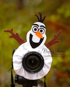 a snowman with a camera attached to it