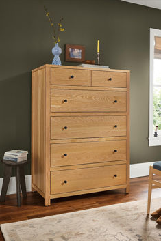 a wooden dresser sitting on top of a hard wood floor