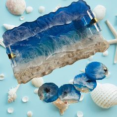 two blue sea glass bottles sitting on top of shells