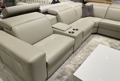 a large sectional couch with multiple recliners on display