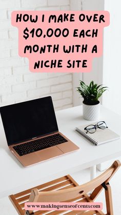 a laptop computer sitting on top of a white desk next to a potted plant