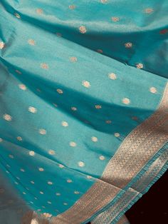 Beautiful Pastel Sea Blue Handmade Dupatta with Koniya design and small buttis all over the dupatta. Super Light weight and very easy to carry. Can be worn with a Suit or lehenga easily. Item: DupattaBase color : Sea Blue Zari Work : Muted Gold Fabric : Premium quality Banarasi Soft SilkWork : Zari Weaved with tasselsLength of the dupatta : 92 inches Width of the dupatta : 37 inches Store Policies - No return or exchange will be accepted for color variations. - No return or exchange will be acce Turquoise Bollywood Blouse Piece With Dupatta, Festive Turquoise Blouse With Zari Work, Traditional Turquoise Blouse Piece For Festivals, Bollywood Style Turquoise Blouse With Dupatta, Traditional Turquoise Blouse For Festivals, Turquoise Blouse Piece With Traditional Drape For Festivals, Traditional Drape Blouse Piece In Turquoise For Festivals, Turquoise Traditional Drape Blouse Piece For Festivals, Turquoise Festive Blouse Piece With Traditional Drape