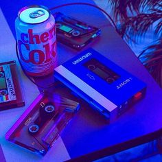 a table topped with cassettes and a can of beer