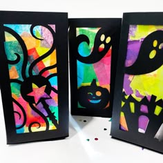 three pieces of art made out of paper with black frames and colorful designs on them