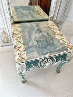 two tables with paintings on them in front of a mirror