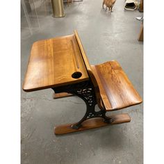 a wooden table with two benches on it in a room full of other tables and chairs