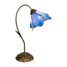 Our Poleking series of table lamps is an easy way to add unique color and charm to any room of your home. This 1 light lily lamp features a single gossamer lily blossom in light blue art glass. Each of the 5 panels feature fluid, graceful edges that faithfully recreate a delicate lily blossom. The shade hangs from a gracefully curved stem flowing from an intricately carved metal base, finished dark antique bronze. This 1 light lamp adds a splash of color on a bookshelf and is also a beautiful desk lamp. No matter how you choose to display it, this charming lamp is destined to become a treasured family heirloom to be enjoyed for generations to come. Measurements: 8 Width/Inches, 19 Height/Inches, 8 Depth/InchesBase Material: 100% MetalFinish: BronzeShade Material: GlassControl Types: On/Off Lily Lamp, Light Blue Art, Beautiful Desk, Lamp Color, Family Heirloom, Blue Art, Light Lamp, Metal Base, Unique Colors