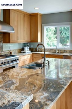 a kitchen with marble counter tops and wooden cabinets, an oven and sink are in front of the window