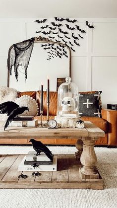 a living room filled with furniture and lots of bats hanging on the wall above it