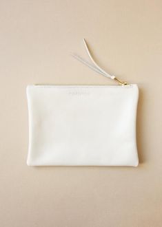 Pearl Ivory classic clutch purse with a wonderful gold tone brass zip. This little purse make a perfect gift for your best friend or someone from your family. The perfect little leather purse that can be used as a make-up bag, wallet, evening purse or to organize your essentials - as your phone, card, keys - in your larger bag. This pouch is an elegant, understated accessory staple.Dimensions are 18.5 cm / 7.3" in width and 14 cm / 5.5" in height.Made with brass zip closure and unlined.Image 4 a White Zipper Pouch For Everyday Use, Everyday White Zipper Pouch, Elegant Everyday Coin Purse With Zipper, Classic Clutch With Removable Pouch As Gift, Elegant Cream Wallets For Everyday Use, Elegant Cream Wallet For Everyday Use, Classic White Wallets For Everyday Use, Classic Everyday White Wallets, Classic White Wedding Bag