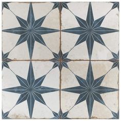 an old tile floor with black and white star designs on the top, bottom and bottom