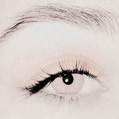 a woman's eye with long black lashes