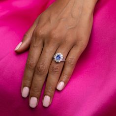 The Story A beautiful cluster ring made during the Edwardian era from period perfect platinum. Sitting at center is a striking old cut oval sapphire in a gorgeous blue hue. Prong set, the sapphire is surrounded by a halo of 10 chunky Old Mine cut diamonds each weighing approximately 0.10 carats. The tapered shank sees lovely open work and is set with an additional 8 rose cut diamonds for a total of a little over 1 carat of diamonds. From circa 1910, this antique ring is in gorgeous condition. Th Wedding Cluster Ring With Rose Cut Diamonds And Sapphire, Heirloom Sapphire Halo Ring With Halo Setting, Heirloom Blue Sapphire Ring With Rose Cut Diamonds, Heirloom Sapphire Halo Ring With Center Stone, Rose Cut Sapphire Cluster Ring, Timeless Sapphire Cluster Ring With Prong Setting, Timeless Blue Sapphire Ring With Rose Cut Diamonds, Heirloom Style Sapphire Cluster Ring With Brilliant Cut, Blue Round Sapphire Ring With Rose Cut Diamonds