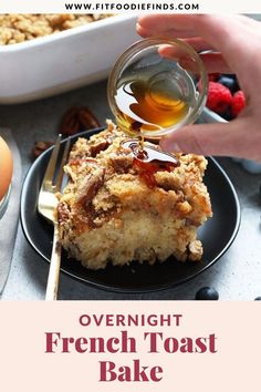 overnight french toast bake on a black plate with berries and an egg in the background