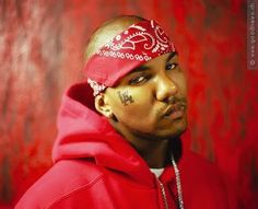 a man in a red hoodie with tattoos on his face