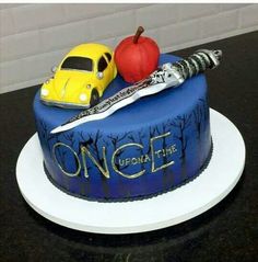 there is a cake that has an apple and knife on it with the words once written on it