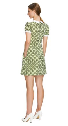 SEASON'S END SALE! LImited quantity left. Fitted sixties style, shades of navy blue, a-line dress; a versatile piece suitable for both work and play. This dress features a charming floral pattern in various shades of green, exuding a delightful retro vibe. The style features a white bib offset by a 4-button-detailed tab, slightly puffed short sleeves, and functional side pockets, adding a touch of timeless elegance and practicality to the ensemble. To suit your style, this dress is also availabl Retro A-line Mini Dress For Work, Retro Short Sleeve Mini Dress For Work, Mod Mini Dress For Work, Fitted Mod Mini Dress For Work, Retro Mini Length Workwear Dresses, Retro Mini Workwear Dresses, Retro Cotton Dresses For Work, Green Cotton Mini Dress For Work, Retro Cotton Workwear Dress