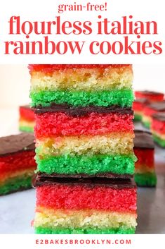 a stack of rainbow cake slices sitting on top of a table