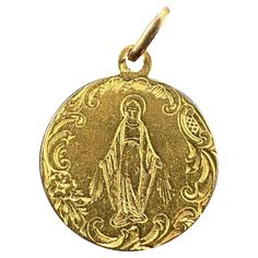 A French 18 karat (18K) yellow gold charm pendant designed as a round medal engraved with the Virgin Mary within an engraved scrolled border. Stamped with the eagle's head for 18 karat gold and French manufacture. Dimensions: 2.1 x 1.8 x 0.06 cm (not including jump ring) Weight: 2.34 grams (Chain not included) Art Nouveau Pendant, The Virgin Mary, Antique Pendant, Eagle Head, Antique Necklace, Yellow Gold Pendants, Pendant Design, Gold Charm, Virgin Mary