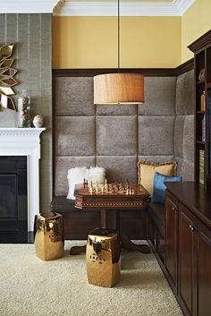 a living room filled with furniture and a fire place in front of a tv mounted on a wall