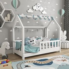 a child's bedroom with gray walls and white furniture, including a crib