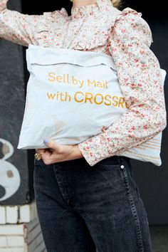 woman holding a Crossroads Sell by Mail bag Selling Clothes Online, The Crossroads, The Process, Online Clothing